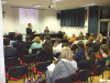  Il Portavoce, Luca Poma, relaziona al numeroso pubblico convenuto ad una conferenza serale a Luino (VA)